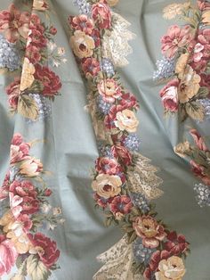 the fabric has flowers on it and is blue