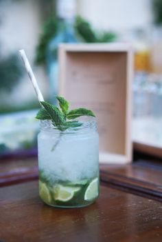 a glass filled with ice and lime slices