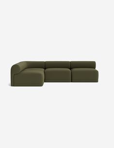 a green couch sitting on top of a white floor