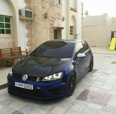 a blue car parked in front of a building