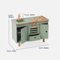 a toy kitchen with an oven and sink in it's side by side measurements