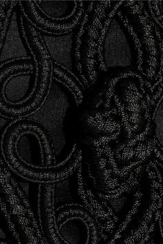 black and white photo of an abstract design on fabric, with the word's initials in