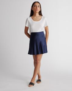 It's mini in length but maximum style points. The washable silk mini skirt is made from 100% washable mulberry silk in a satin finish. Pairs perfectly with our silk cami and has a hidden elastic waistband for easy fit.  | Quince | Women's Washable Silk Mini Skirt in Navy, Size Large, Mulberry Silk Silk Mini Skirt, Silk Cami, Alpaca Sweater, Ponte Pants, Silk Skirt, Mulberry Silk, Quince, Satin Finish, Silk Satin