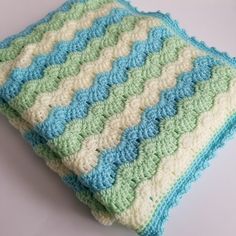 a crocheted blanket sitting on top of a table