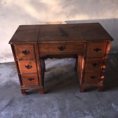 an old wooden desk with two drawers