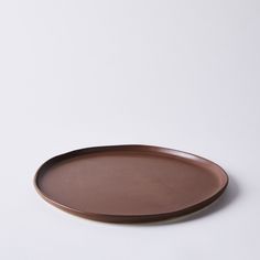 a brown plate sitting on top of a white table