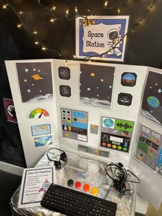 an office cubicle is decorated with space station magnets and pictures on the wall