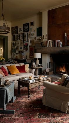 a living room filled with furniture and a fire place in the middle of the room