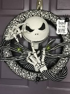 a halloween wreath with a skeleton on it