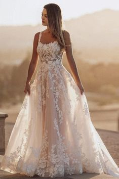 a woman in a wedding dress is standing outside