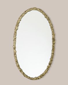 an oval mirror is shown against a wall