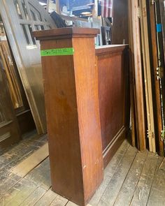 a wooden podium sitting on top of a floor next to a pile of wood planks