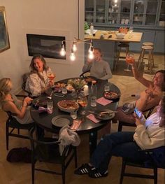 a group of people sitting around a dinner table