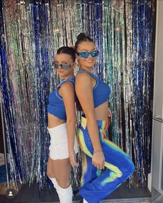 two women in blue and white outfits standing next to each other