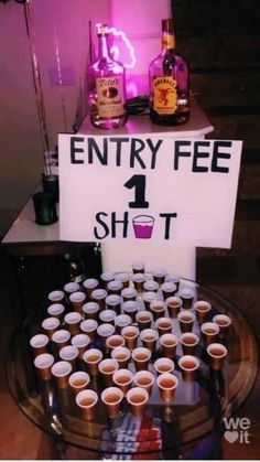 there is a sign that says entry fee 1 shot with cups in front of it