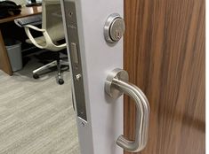 an office door with a metal handle on it