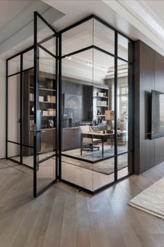 an office with glass walls and wooden floors