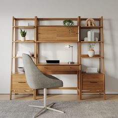 a desk with a chair and bookshelf in the corner, next to a wall mounted shelving unit