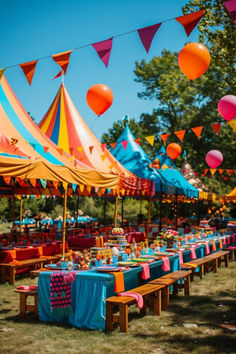 an outdoor party with colorful tents and tables