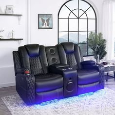 a living room with two reclining chairs and a blue light on the back of it