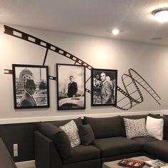 a living room filled with furniture and pictures on the wall