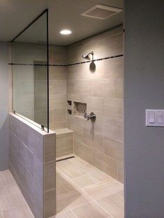 a walk in shower sitting inside of a bathroom