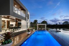 a large swimming pool next to a modern house