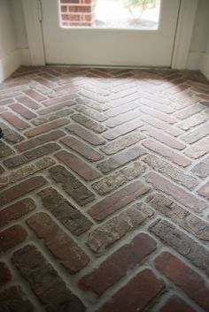 a brick floor in front of a window