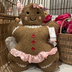 a large teddy bear sitting next to a basket with flowers