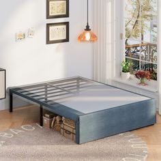 a bed frame that is in the middle of a room with a rug on the floor