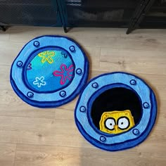 two blue rugs with cartoon characters on them