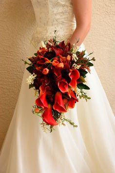 a bride holding a bouquet of flowers in her hand