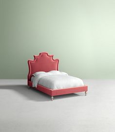 a bed with a pink headboard and foot board