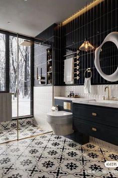 a black and white tiled bathroom with gold accents