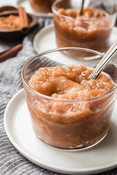 two desserts on plates with spoons in them and one is filled with pudding