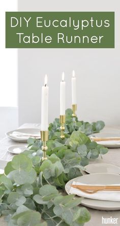 a long table with white plates and candles on it, surrounded by greenery in front of the words diy eucalyptus table runner