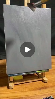 an easel with a painting on it and a remote control