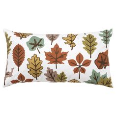 a white pillow with colorful leaves on it