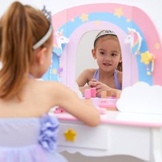 KIDS VANITY TABLE: Features a rainbow unicorn design with pink and purple accents for a fun and functional addition to your child's bedroom or play area COMPLETE SET: Includes an arch-shaped mirror and coordinating stool to make getting ready easy BUILT-IN STORAGE: One center drawer, two cloud shaped drawers, and star & unicorn shaped hooks provide plenty of storage space for makeup, brushes, jewelry, and other accessories MADE WITH EASY-TO-CLEAN MDF: Durable MDF construction with rounded corner Kids Vanity Set, Kids Dressing Table, Fantasy Fields, Mirror Stool, Dressing Table Vanity, Vanity Table Set, Vanity Set With Mirror, Storage Stool, Kids Vanity