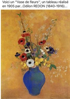 a blue vase filled with lots of colorful flowers on top of a wooden table next to a yellow wall