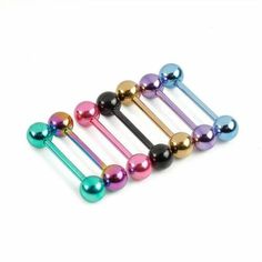 six different colored metal balls and pins on a white background