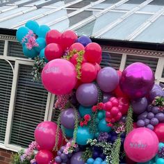 balloons and flowers decorate the outside of a house