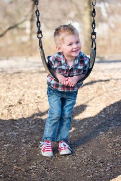 a little boy that is sitting on a swing