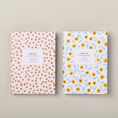 two notebooks with yellow and blue flowers on them