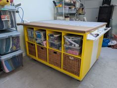 a yellow table with baskets on it in a room