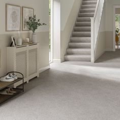 a living room with carpeted floors and stairs