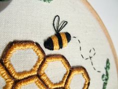 a close up of a cross stitch bee and honeycomb