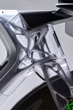 the rear view mirror of a silver car with chrome trims and an abstract design on it