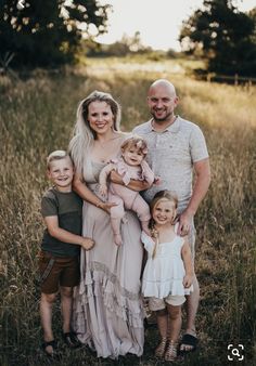 a family posing for a photo in a field