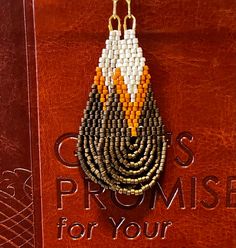 a book with an orange and white beaded design on it